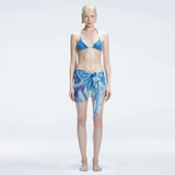 Evita Blue Optical Tie Side Sarong | Moeva | Sarong | Each week unveils new pieces—luxury swimwear, fluid resort silhouettes, and elevated summer-to-evening essentials designed to carry you from coastal escapes to city nights.