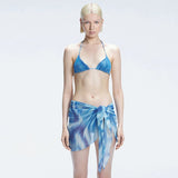 Evita Blue Optical Tie Side Sarong | Moeva | Sarong | Each week unveils new pieces—luxury swimwear, fluid resort silhouettes, and elevated summer-to-evening essentials designed to carry you from coastal escapes to city nights.
