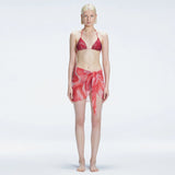 Evita Red Optical Tie Side Sarong | Moeva | Sarong | Each week unveils new pieces—luxury swimwear, fluid resort silhouettes, and elevated summer-to-evening essentials designed to carry you from coastal escapes to city nights.