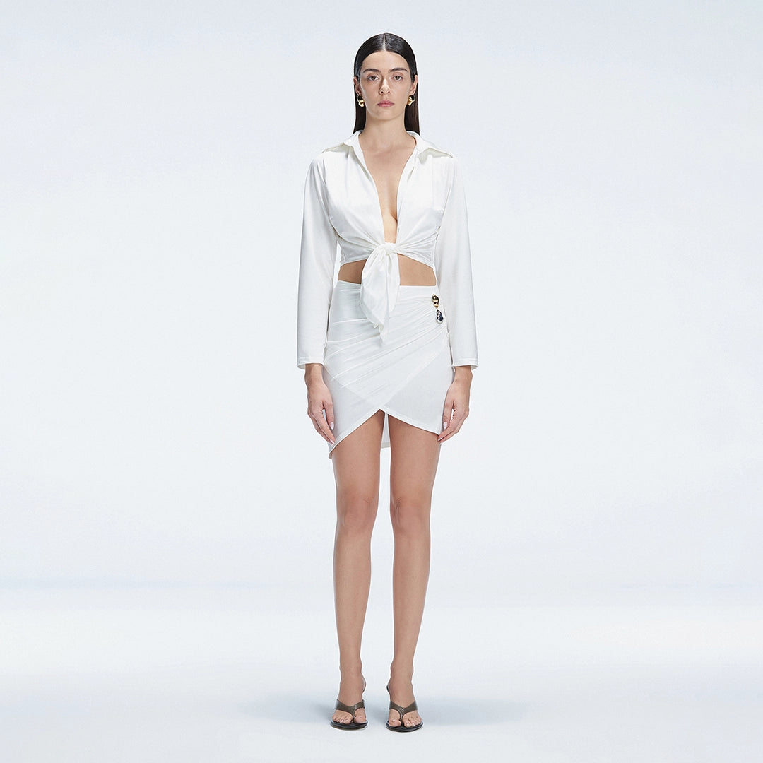 Greta White Long Sleeve Tie Front Shirt and Antonia White High-Waist Wrap Mini Skirt | Moeva | | Each week unveils new pieces—luxury swimwear, fluid resort silhouettes, and elevated summer-to-evening essentials designed to carry you from coastal escapes to city nights.