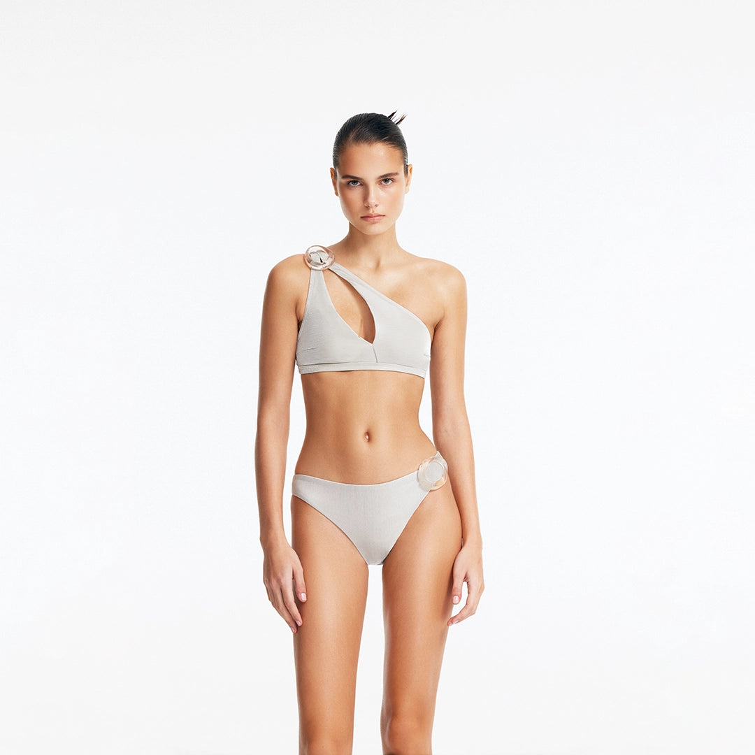 Calix Silver One Shoulder Bikini Top | Moeva | Bikini Top | Each week unveils new pieces—luxury swimwear, fluid resort silhouettes, and elevated summer-to-evening essentials designed to carry you from coastal escapes to city nights.