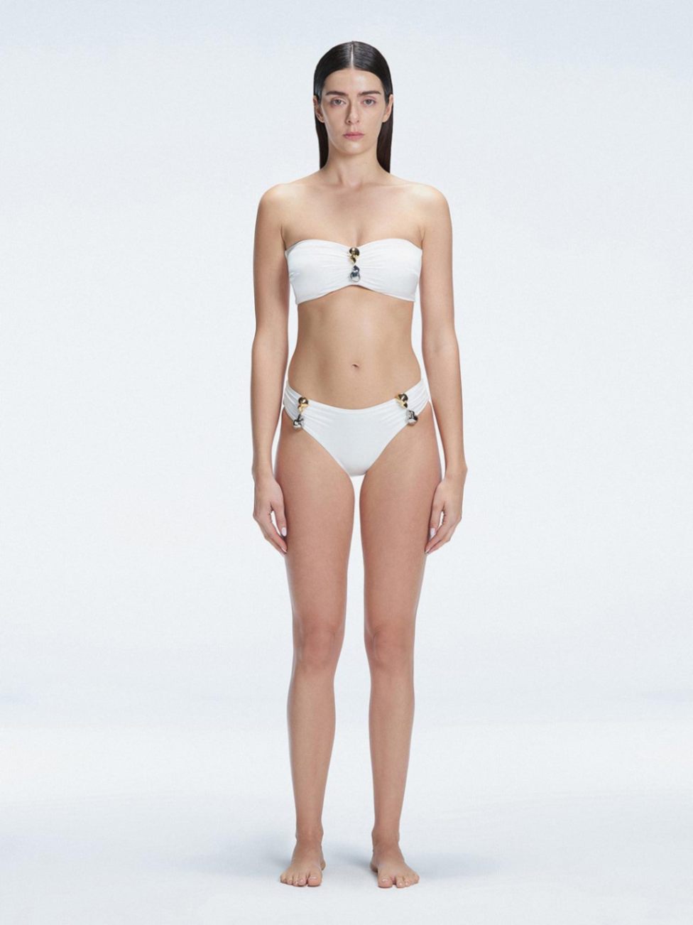 "Model wearing the Ilana White Bandeau Bikini Set with buckle and ruched detailing, posing by the pool."