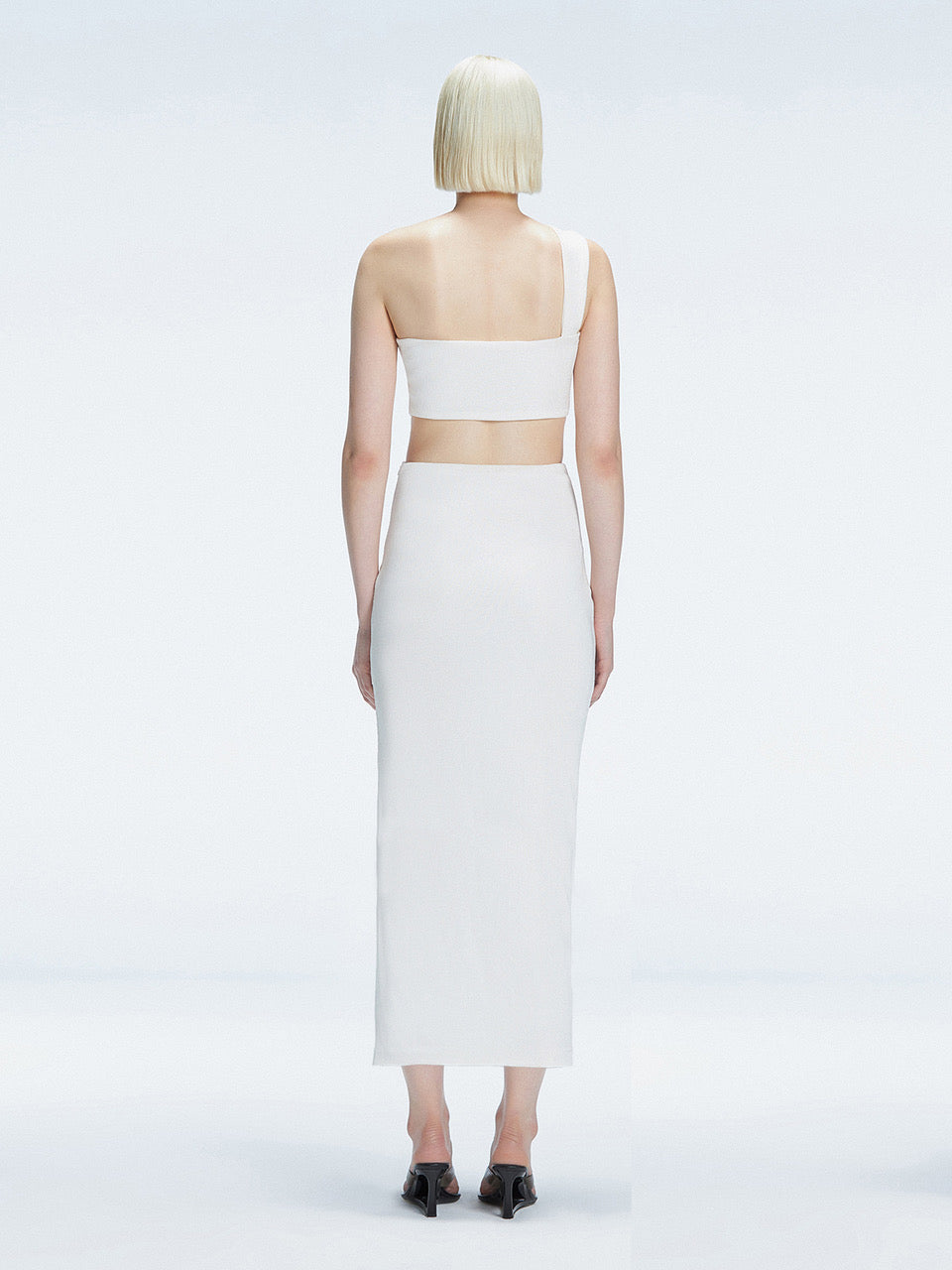 Lane One-Shoulder Black Crop Top and Esmeralda Maxi Skirt with Front Ruched Detail | Moeva | Set | Each week unveils new pieces—luxury swimwear, fluid resort silhouettes, and elevated summer-to-evening essentials designed to carry you from coastal escapes to city nights.
