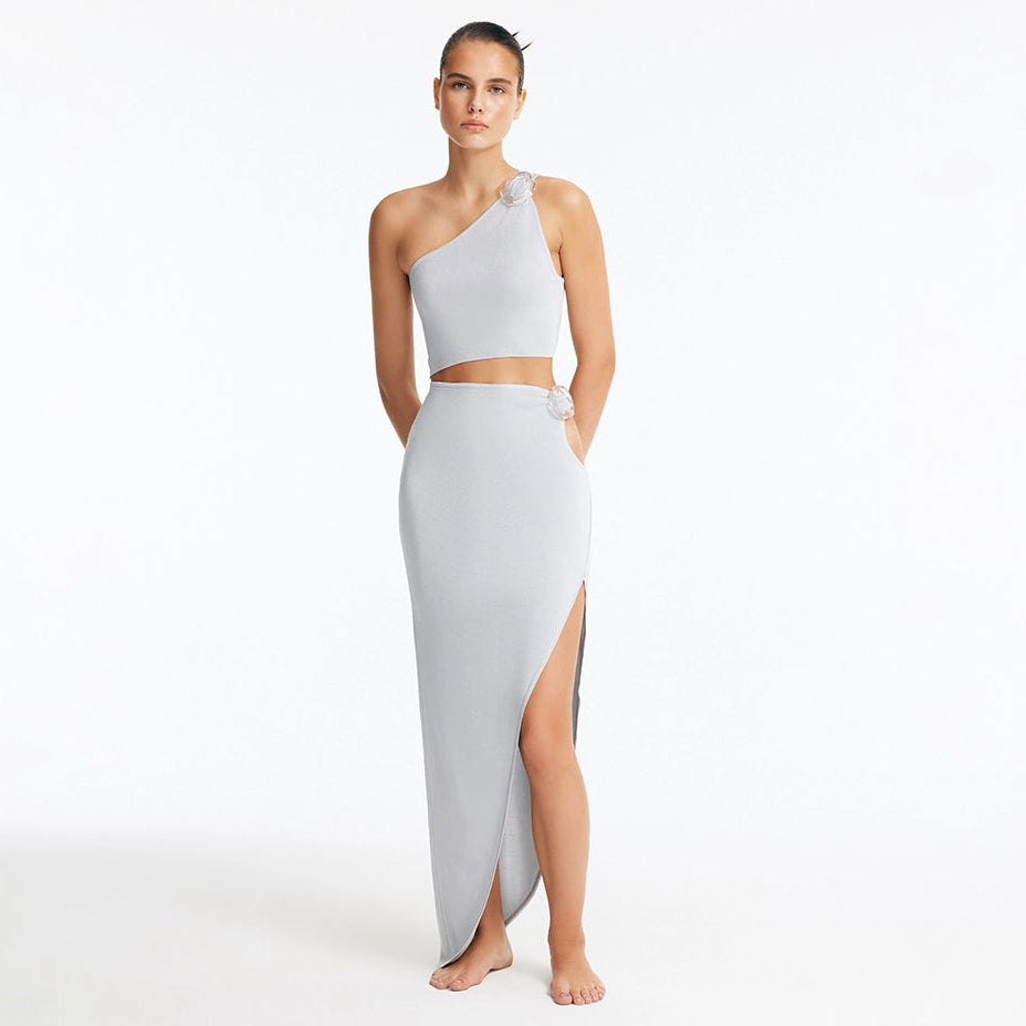Eila Silver One Shoulder Knitted Crop Top and Lyndon Silver Knitted Skirt with Side Slit | Moeva | Set | Each week unveils new pieces—luxury swimwear, fluid resort silhouettes, and elevated summer-to-evening essentials designed to carry you from coastal escapes to city nights.