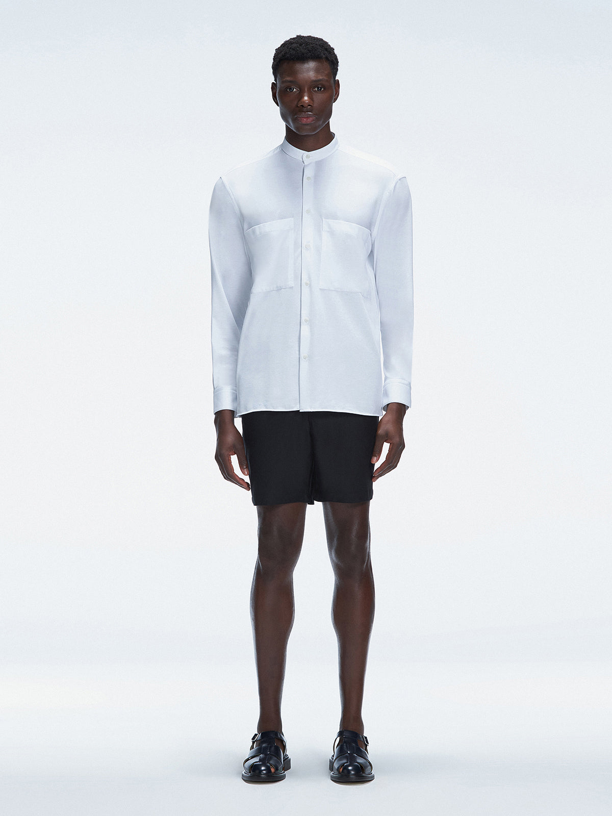 Model wearing the Lucius White Shirt with a mandarin collar and fitted design.