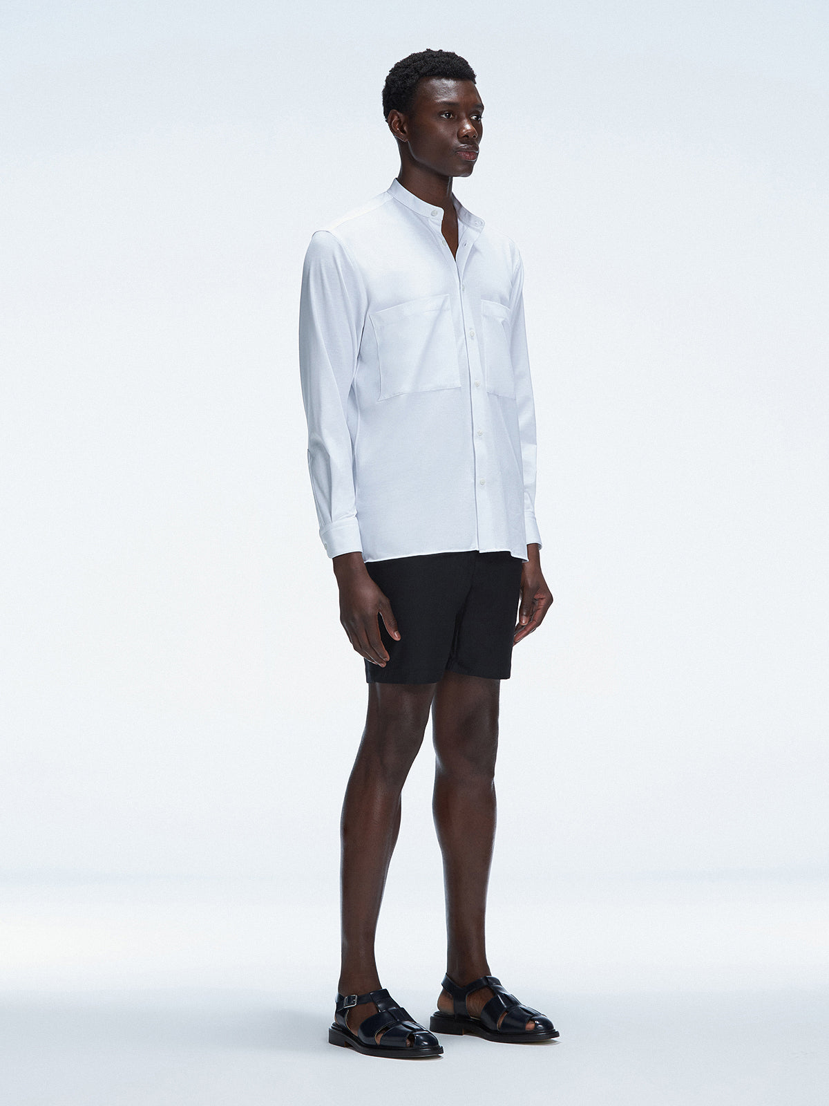 Side view of the Lucius White Shirt on a model, highlighting the clean lines and modern mandarin collar.