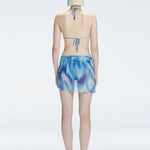 Evita Blue Optical Tie Side Sarong | Moeva | Sarong | Each week unveils new pieces—luxury swimwear, fluid resort silhouettes, and elevated summer-to-evening essentials designed to carry you from coastal escapes to city nights.
