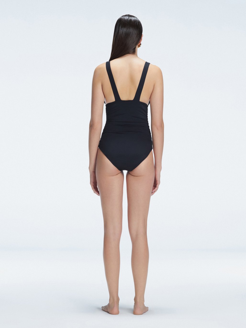Griselda Black V-Neck Ruched Swimdress with Gold Detail | Moeva | Swimsuit | Each week unveils new pieces—luxury swimwear, fluid resort silhouettes, and elevated summer-to-evening essentials designed to carry you from coastal escapes to city nights.