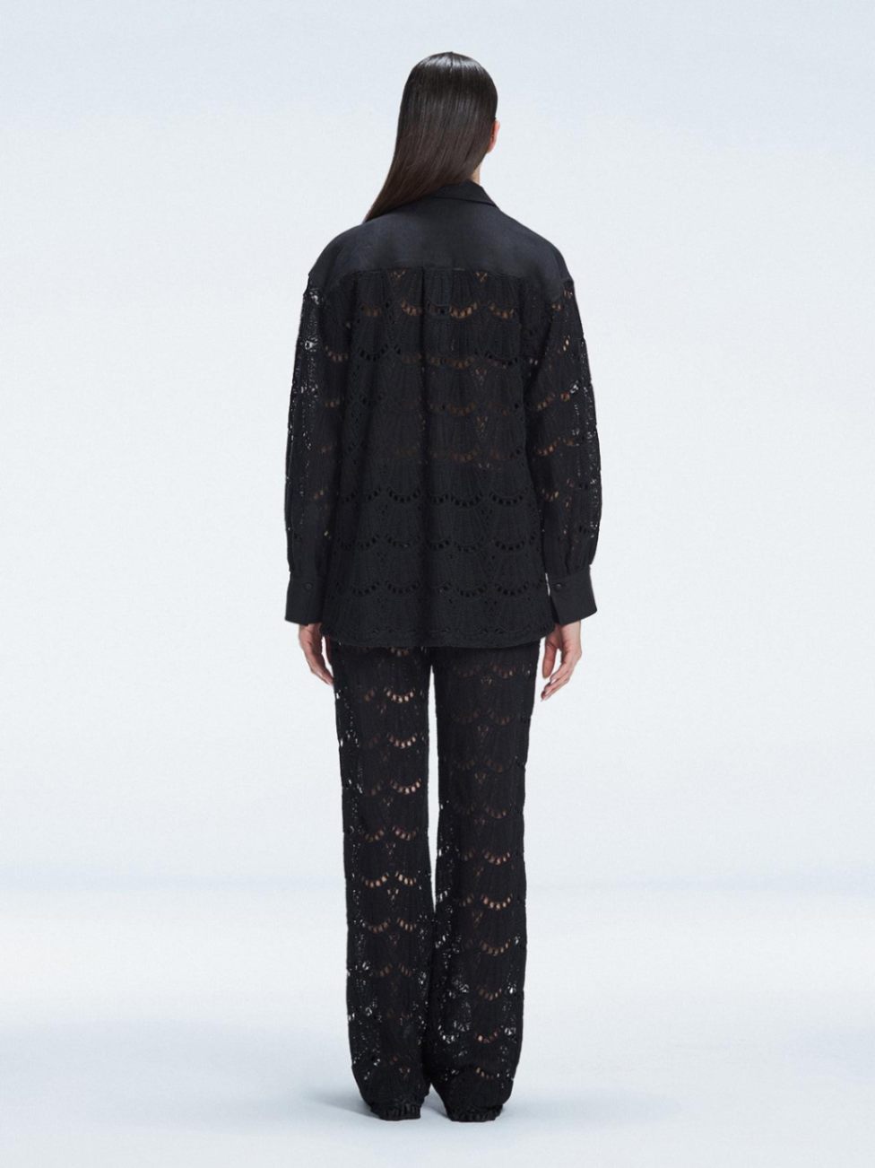 Back view of model wearing Nola Black Shirt and Elysia Pants, highlighting the classic button-down silhouette.