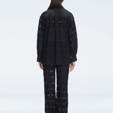 Back view of model wearing Nola Black Shirt and Elysia Pants, highlighting the classic button-down silhouette.