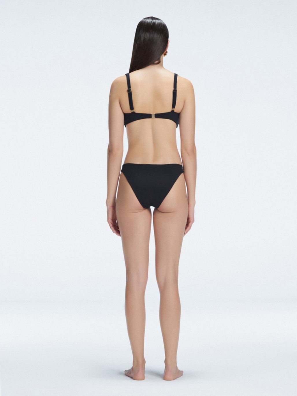 Zella Black Mid Coverage Solid Bikini Bottom | Moeva | Bikini Bottom | Each week unveils new pieces—luxury swimwear, fluid resort silhouettes, and elevated summer-to-evening essentials designed to carry you from coastal escapes to city nights.
