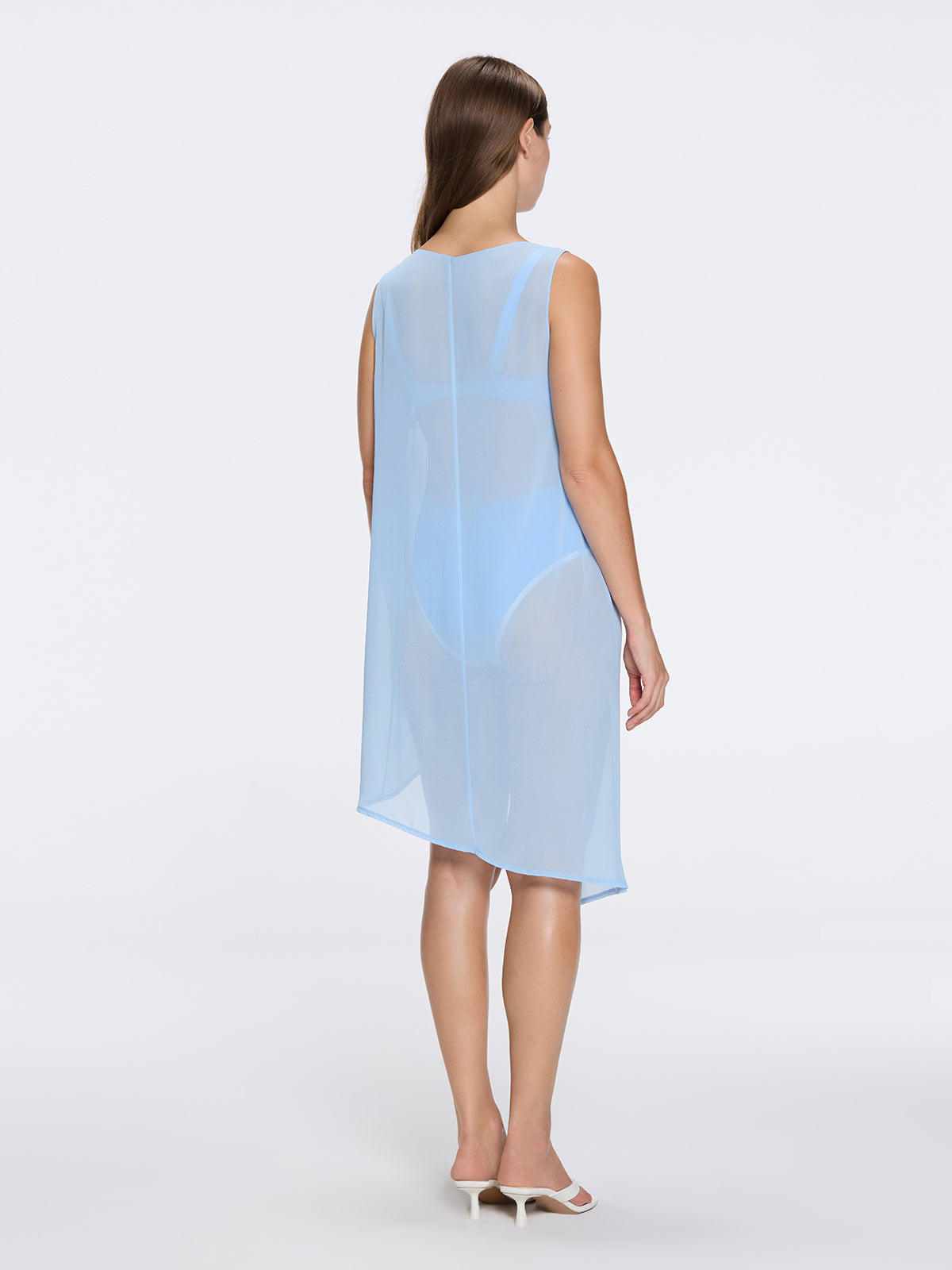 Solianne Blue Sheer Sleeveless Asymmetric Dress with Gold Button Detail | Moeva | Dress | Each week unveils new pieces—luxury swimwear, fluid resort silhouettes, and elevated summer-to-evening essentials designed to carry you from coastal escapes to city nights.