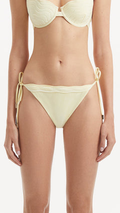 Salila Yellow Side Tie Wave Textured Bikini Bottom | Moeva | Bikini Bottom | Each week unveils new pieces—luxury swimwear, fluid resort silhouettes, and elevated summer-to-evening essentials designed to carry you from coastal escapes to city nights.