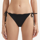 Salila Black Side Tie Wave Textured Bikini Bottom | Moeva | Bikini Bottom | Each week unveils new pieces—luxury swimwear, fluid resort silhouettes, and elevated summer-to-evening essentials designed to carry you from coastal escapes to city nights.