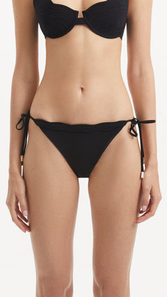 Salila Black Side Tie Wave Textured Bikini Bottom | Moeva | Bikini Bottom | Each week unveils new pieces—luxury swimwear, fluid resort silhouettes, and elevated summer-to-evening essentials designed to carry you from coastal escapes to city nights.