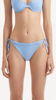 Salila Baby Side Tie Wave Textured Blue Bikini Bottom | Moeva | Bikini Bottom | Each week unveils new pieces—luxury swimwear, fluid resort silhouettes, and elevated summer-to-evening essentials designed to carry you from coastal escapes to city nights.