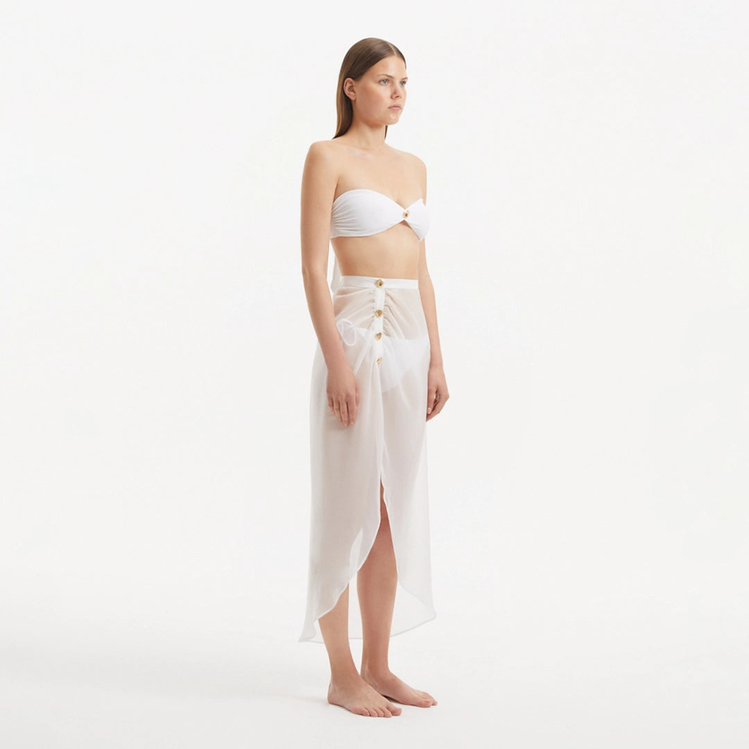 Xander White Sheer Maxi Skirt with Gold Button Details | Moeva | Skirt | Each week unveils new pieces—luxury swimwear, fluid resort silhouettes, and elevated summer-to-evening essentials designed to carry you from coastal escapes to city nights.