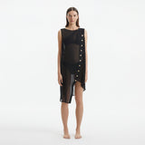Adora Black Sheer Sleeveless Asymmetric Dress with Gold Button Detail | Moeva | Dress | Each week unveils new pieces—luxury swimwear, fluid resort silhouettes, and elevated summer-to-evening essentials designed to carry you from coastal escapes to city nights.