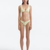 Aeron Yellow V Neck Textured Bikini Top | Moeva | Bikini Top | Each week unveils new pieces—luxury swimwear, fluid resort silhouettes, and elevated summer-to-evening essentials designed to carry you from coastal escapes to city nights.