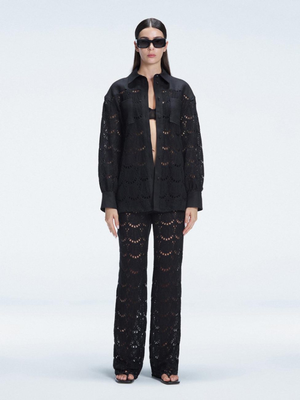 Front view of model wearing Nola Black Shirt and Elysia Pants with button fastening and long sleeves.