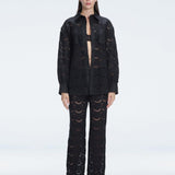 Front view of model wearing Nola Black Shirt and Elysia Pants with button fastening and long sleeves.