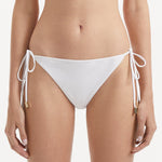 Sarita White Side Tie Bikini Bottom | Moeva | Bikini Bottom | Each week unveils new pieces—luxury swimwear, fluid resort silhouettes, and elevated summer-to-evening essentials designed to carry you from coastal escapes to city nights.