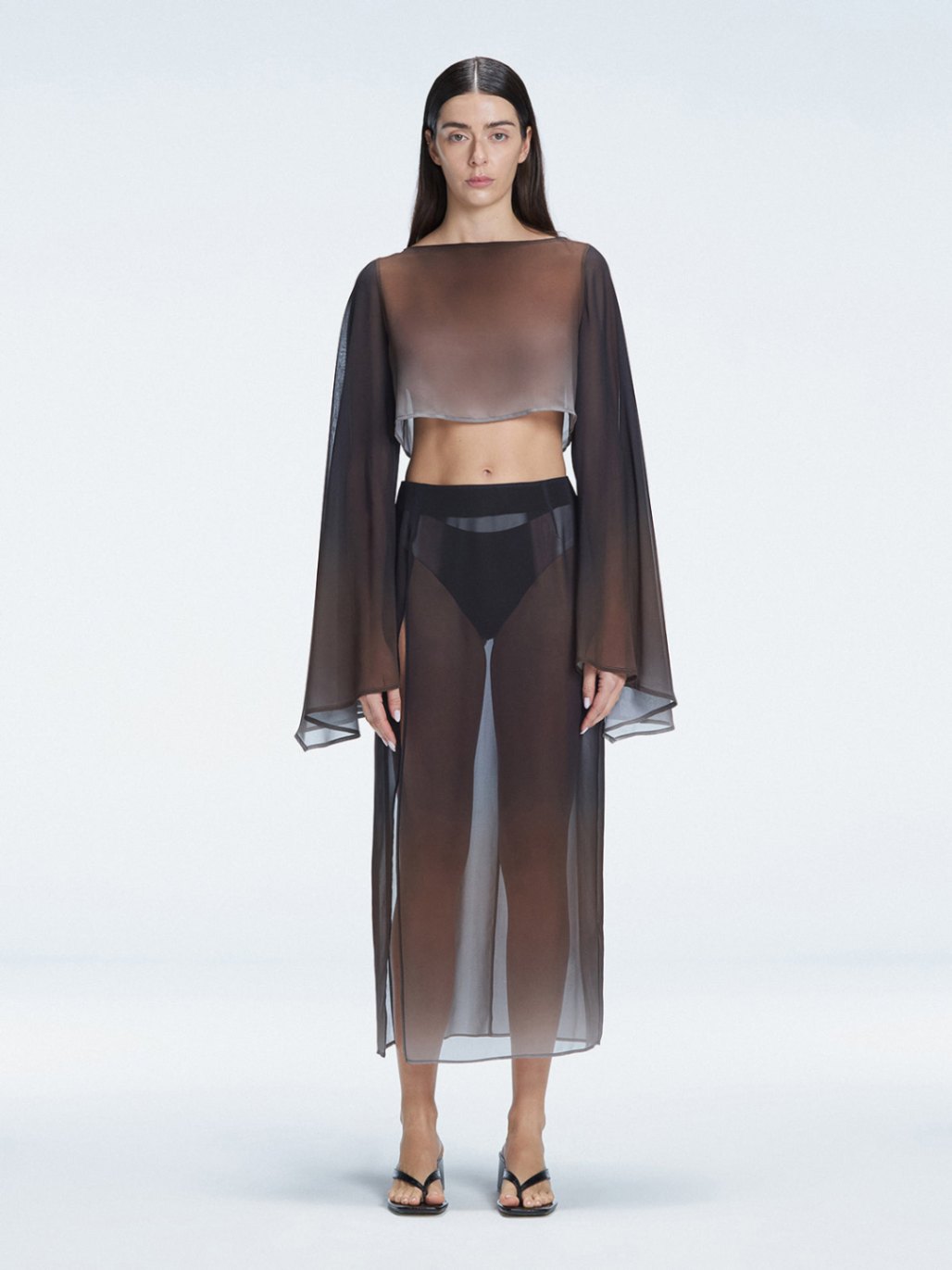 Front view of model wearing Samantha Black Degraded Top and Tabitha Skirt with long sleeves and printed mesh fabric.