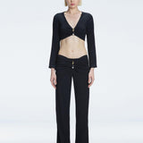 Front view of model wearing Sirenia Black Crop Top and Helena Pants with V-neck, long sleeves, and buckle detail.