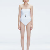 Front view of model wearing Ursula White One Piece swimsuit with strapless silhouette and twisted gold accessory.