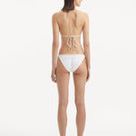 Sarita White Side Tie Bikini Bottom | Moeva | Bikini Bottom | Each week unveils new pieces—luxury swimwear, fluid resort silhouettes, and elevated summer-to-evening essentials designed to carry you from coastal escapes to city nights.