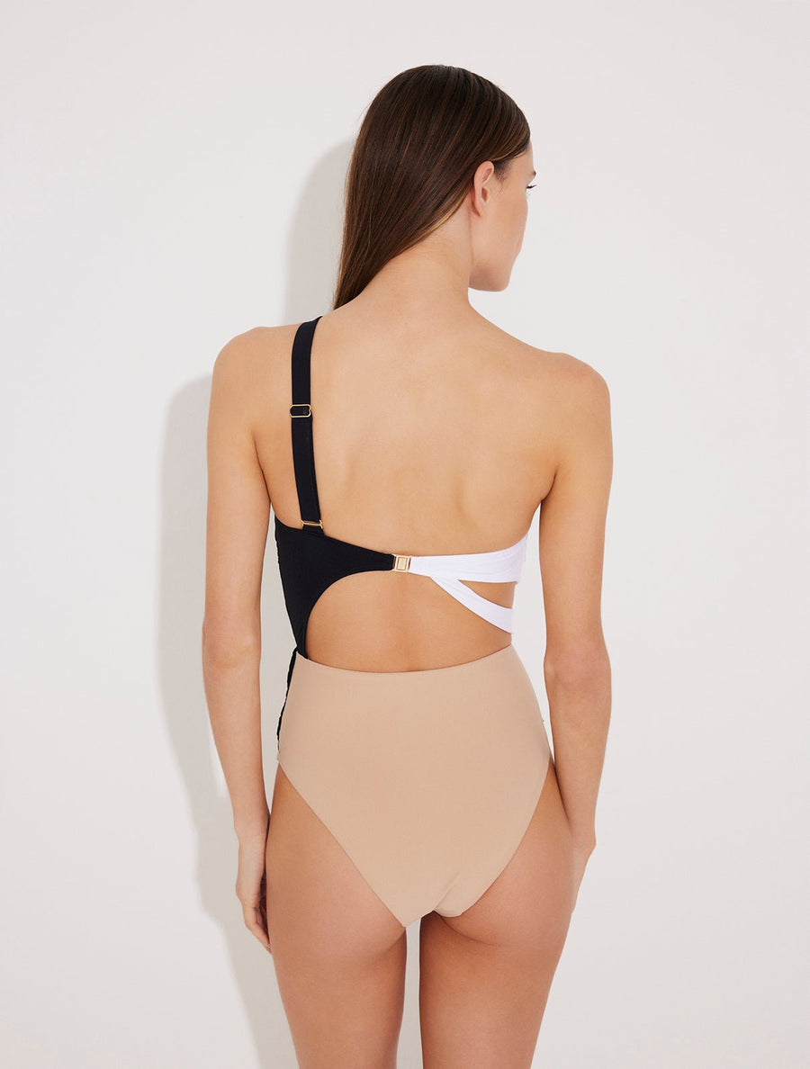 Back View: Model in Adelina Black/Nude/White Swimsuit - MOEVA Luxury Swimwear, Asymmetric Cutouts Accented With Drapes, One Shoulder, Gold Clasps at the Back, Rectangular Accessories, Moderate Bottom Coverage, One Piece Swimsuit, MOEVA Luxury Swimwear 