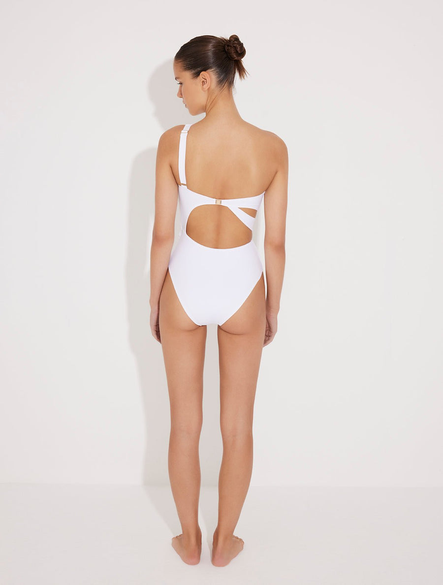 Back View: Model in Adelina White Swimsuit  - MOEVA Luxury Swimwear, Asymmetric Cutouts Accented With Drapes, One Shoulder, Gold Clasps at the Back, Rectangular Accessories, Moderate Bottom Coverage, One Piece Swimsuit, MOEVA Luxury Swimwear 