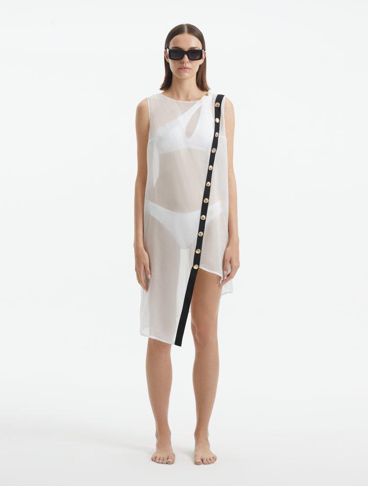 Adora White Sheer Sleeveless Asymmetric Dress with Gold Button Detail | Moeva | Dress | Each week unveils new pieces—luxury swimwear, fluid resort silhouettes, and elevated summer-to-evening essentials designed to carry you from coastal escapes to city nights.