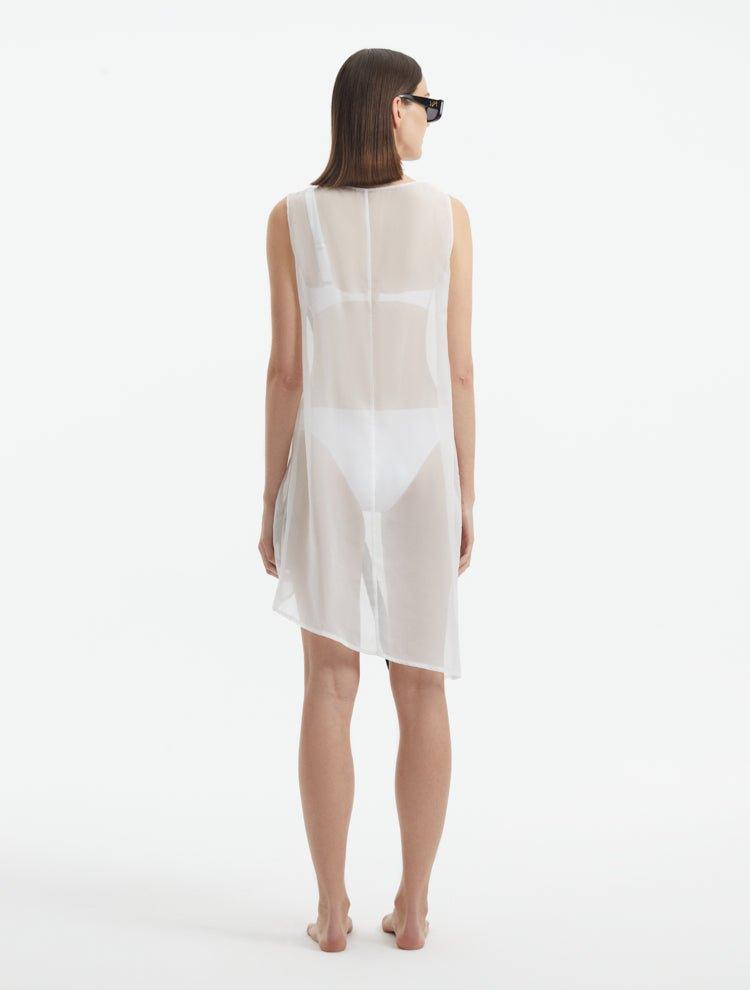 Adora White Sheer Sleeveless Asymmetric Dress with Gold Button Detail | Moeva | Dress | Each week unveils new pieces—luxury swimwear, fluid resort silhouettes, and elevated summer-to-evening essentials designed to carry you from coastal escapes to city nights.