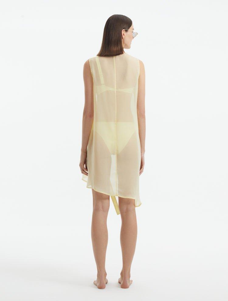 Adora Yellow Sheer Sleeveless Asymmetric Dress with Gold Button Detail | Moeva | Dress | Each week unveils new pieces—luxury swimwear, fluid resort silhouettes, and elevated summer-to-evening essentials designed to carry you from coastal escapes to city nights.