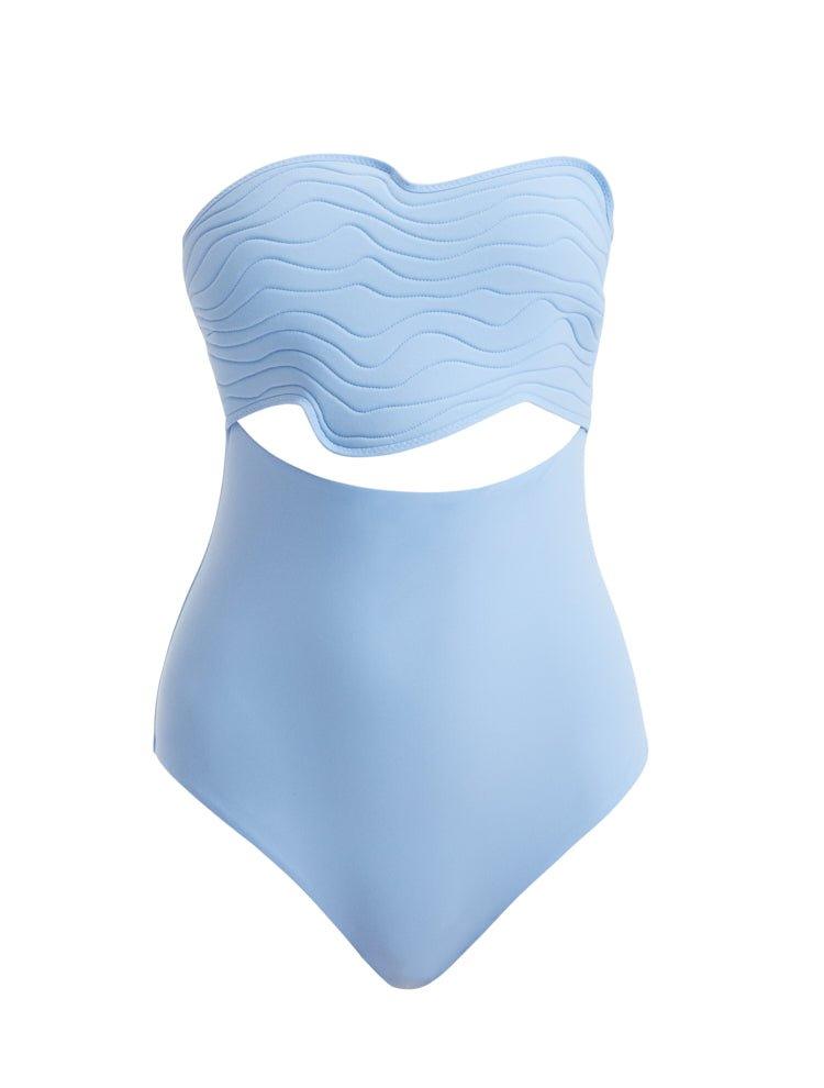 Close-up of Adria Blue Swimsuit focusing on the cut-out details along the sides. The wavy texture and premium Italian fabric are featured, showcasing the swimsuit's blend of elegance and athletic functionality.