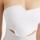 Close-up of Adria White Swimsuit focusing on the wavy texture detailing and adjustable straps. The premium Italian fabric and stylish design elements are featured, emphasizing the blend of elegance and functionality.