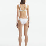 Aeron White V Neck Textured Bikini Top | Moeva | Bikini Top | Each week unveils new pieces—luxury swimwear, fluid resort silhouettes, and elevated summer-to-evening essentials designed to carry you from coastal escapes to city nights.
