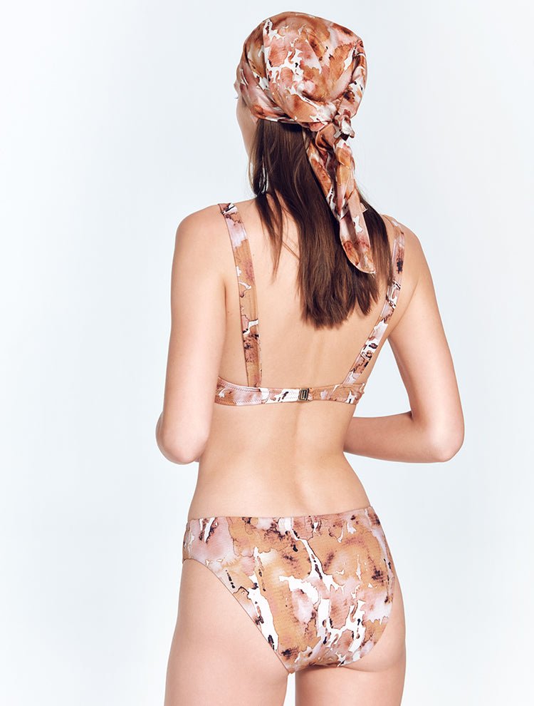 Back View: Model in Alexa Floral Abstract Bikini Top - MOEVA Luxury Swimwear, Gold Clasps at the Back, Lycra XtraLife® Certificate, Italian Fabric, Soft Touch Shiny Fabric, MOEVA Luxury Swimwear
