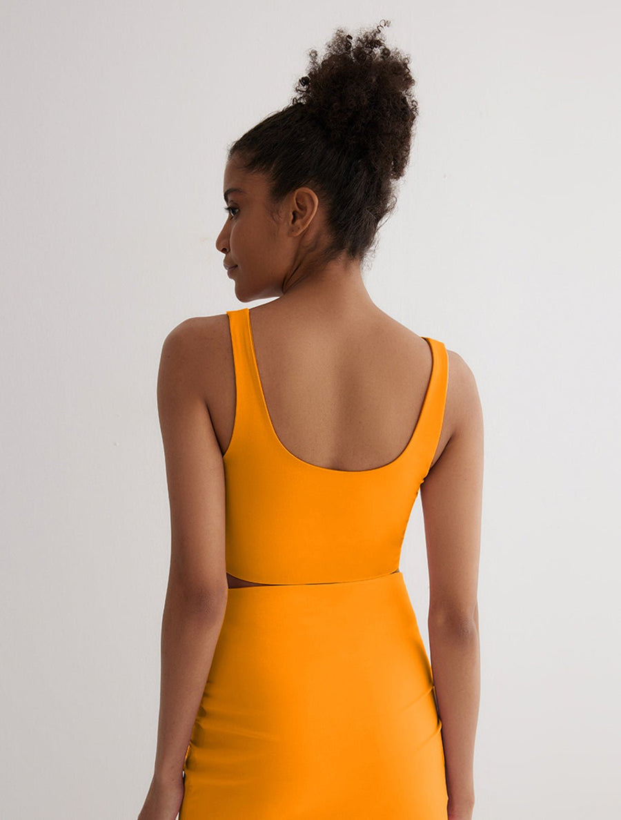 Back View: Model in Alva Orange/Pink Reversible Top - MOEVA Luxury Swimwear, Scoop Neckline and Back, Cropped Length, Stretchy Fabric, MOEVA Luxury Swimwear