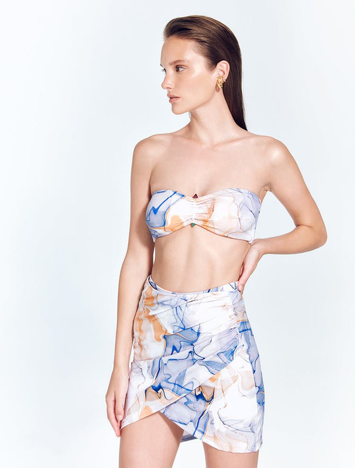 Front View: Model in Antonia Blue Abstract Skirt - MOEVA Luxury Swimwear, Wrap Style, Slim Fit, High Rise, Thigh Length Skirt, MOEVA Luxury Swimwear