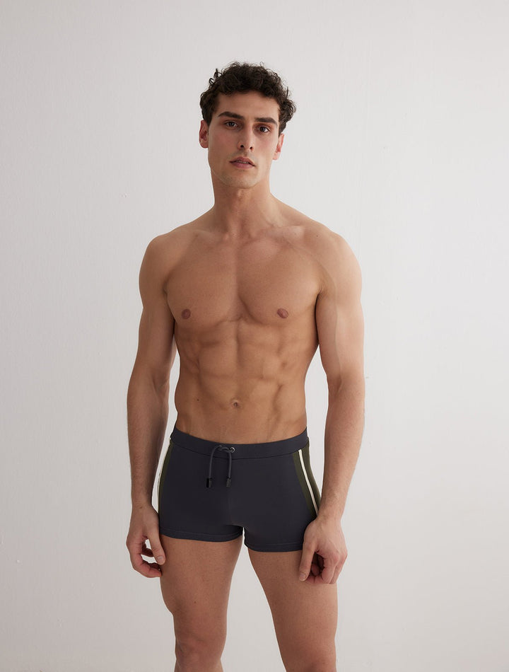Front View: Model in Antonio Grey/Green/White Men Trunks - MOEVA Luxury Swimwear, Duo/Tri-Colored, Elasticated Waistband, Strechy Fabric, Tie at the Front, Quick Dry, Comfortable Fit, MOEVA Luxury Swimwear