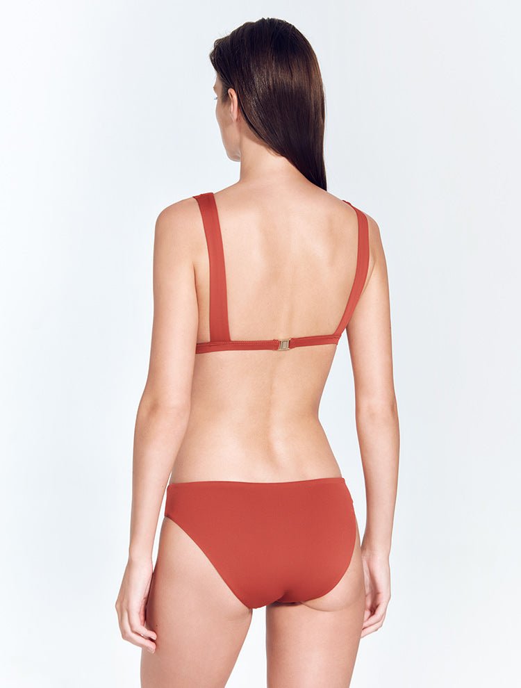 Back View: Model in Aya Red Ochre Bikini Bottom - MOEVA Luxury Swimwear, Classic Briefs, Fully Lined, Comfort and Signature, Soft Touch Shiny Fabric, Lycra XtraLife® Certificate, Italian Fabric, MOEVA Luxury Swimwear