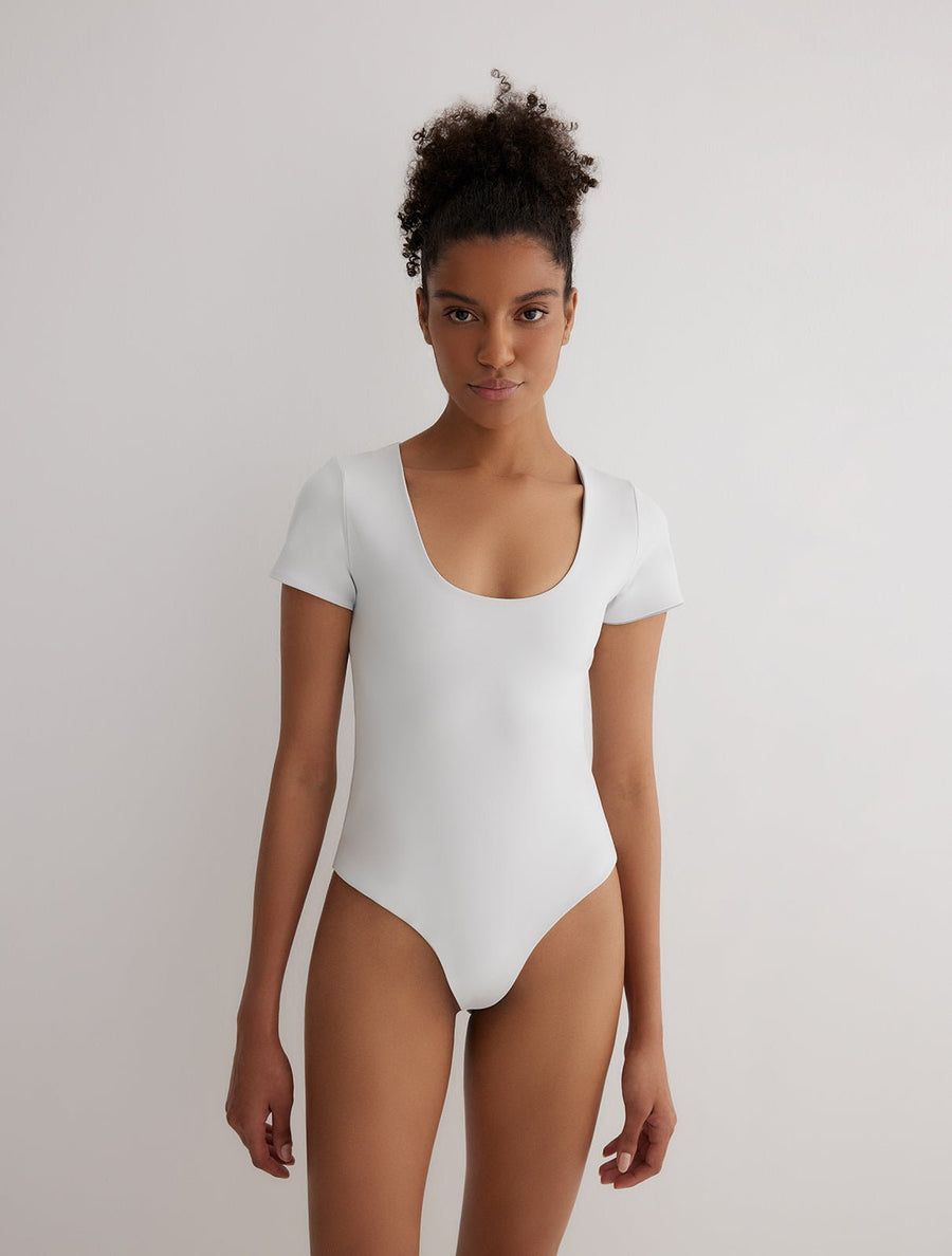 Front View: Model in Britt Grey/White Reversible Bodysuit - French & Italian Fabric, Special Lycra Xtralife Certificate, One Piece Fully Lined Bodysuit, MOEVA Luxury Swimwear