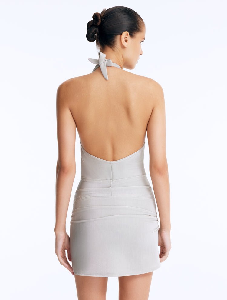 Back View: Clementine Silver Swimsuit on Model - Chic Style, High-Leg Cut, Tie-Front Mini Skirt Detail, Italian Fabric, MOEVA Luxury Swimwear 