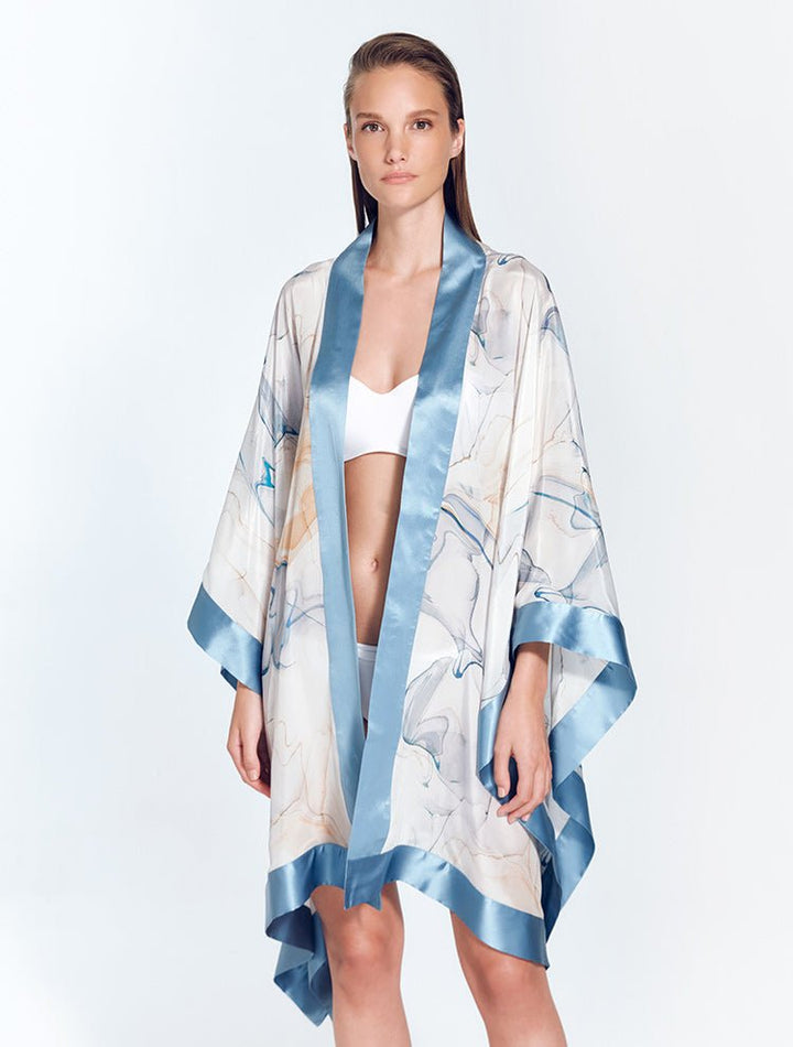 Front View: Model in Delfina Blue Abstract/Nude Kaftan - MOEVA Luxury Swimwear, Long Sleeved, Mid-Thigh Length, Short Silk Kaftan, MOEVA Luxury Swimwear