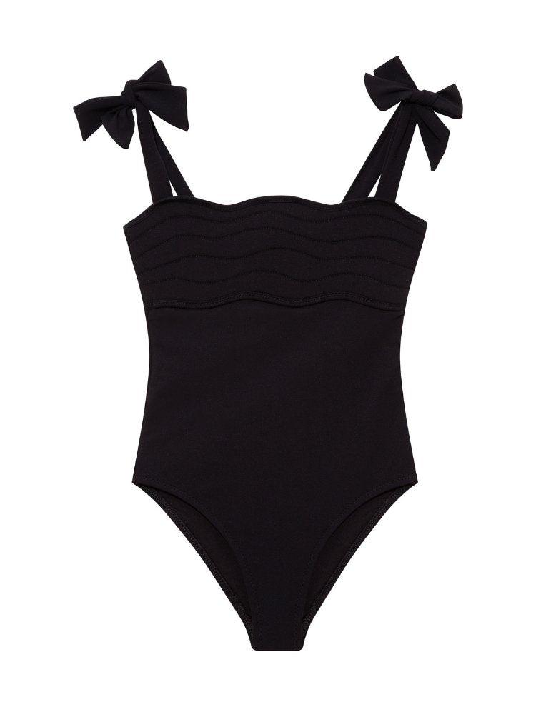 Everlee Black Kids Swimsuit with Bow Strap Detail | Moeva | Kids Swimsuits | Each week unveils new pieces—luxury swimwear, fluid resort silhouettes, and elevated summer-to-evening essentials designed to carry you from coastal escapes to city nights.