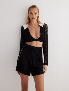 Front View: Model in Freja Black/Nude/White Shorts - MOEVA Luxury Swimwear, Knitted Shorts, Semi-Sheer Panels, High Waisted, Loose Fit, Mid-Thigh Length, Elasticated Waistband, MOEVA Luxury Swimwear