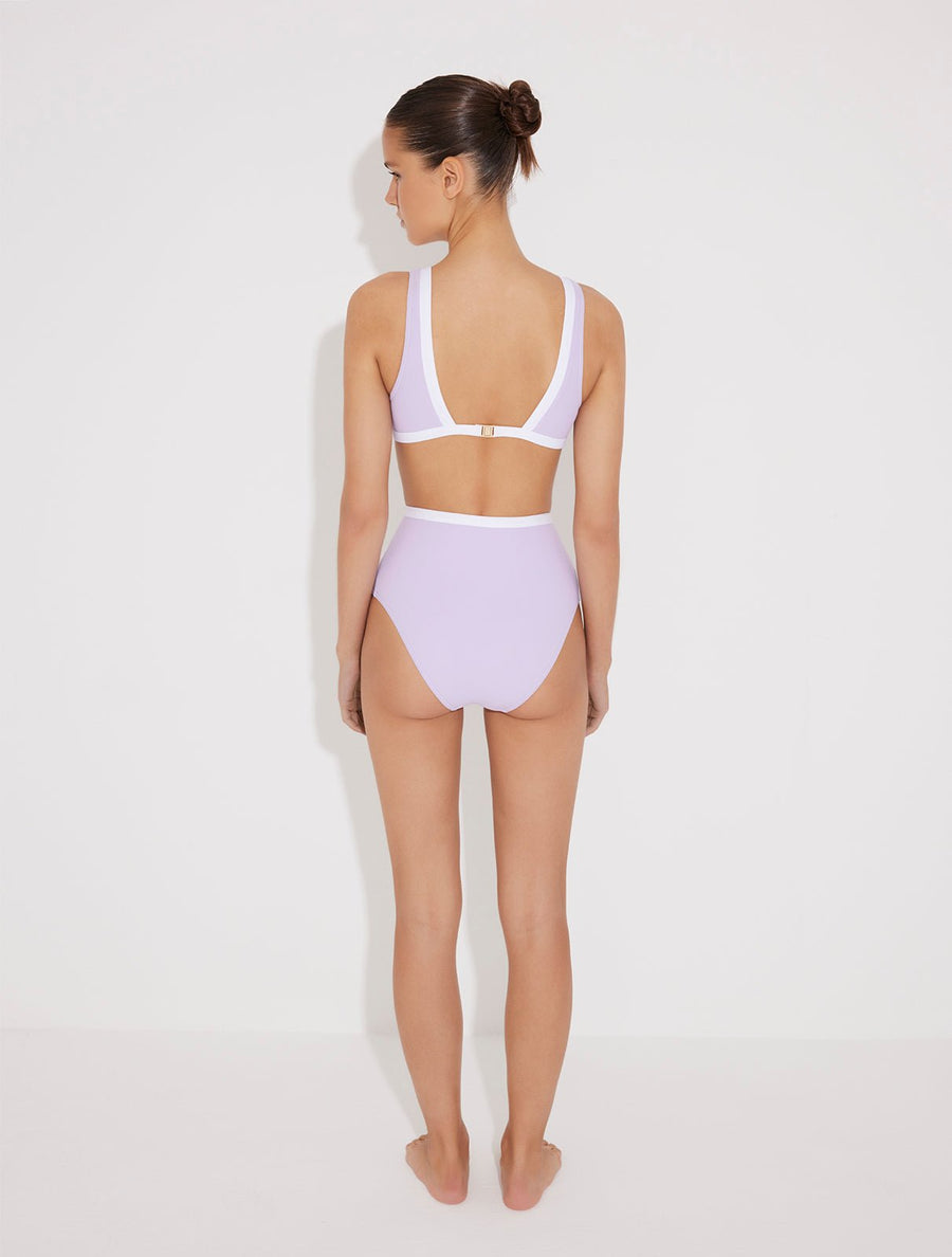 Back View: Model in Greca Lilac/White Bikini Bottom - Moderate Bottom Coverage, Lined, Italian Fabric, Soft Touch Fabric, High-Waisted Swim Bottom, Special Lycra Xtralife Certificate, MOEVA Luxury Swimwear  