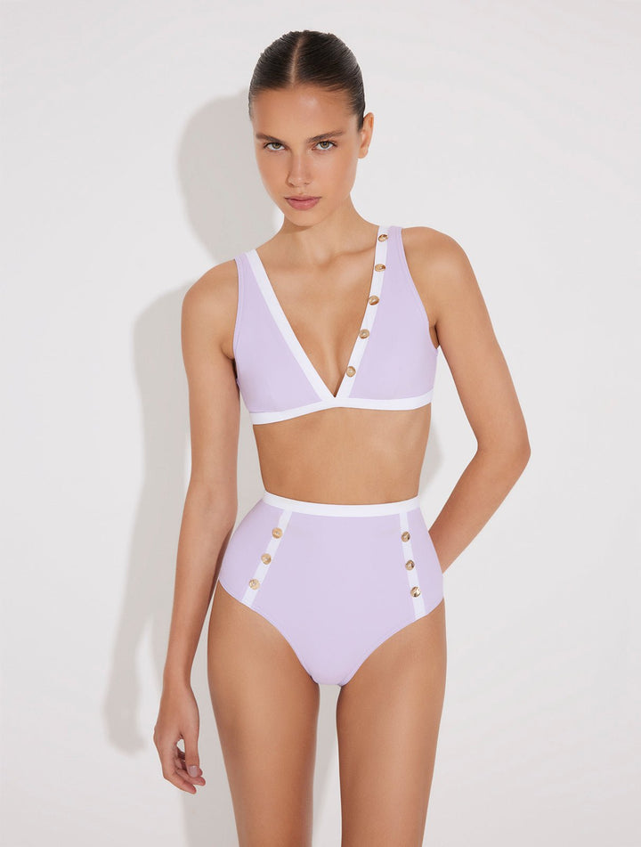 Front View: Model in Greca Lilac/White Bikini Bottom - MOEVA Luxury Swimwear, High-Waist, Gold Button Details, Duo Colored, Full Bottom Coverage MOEVA Luxury Swimwear  